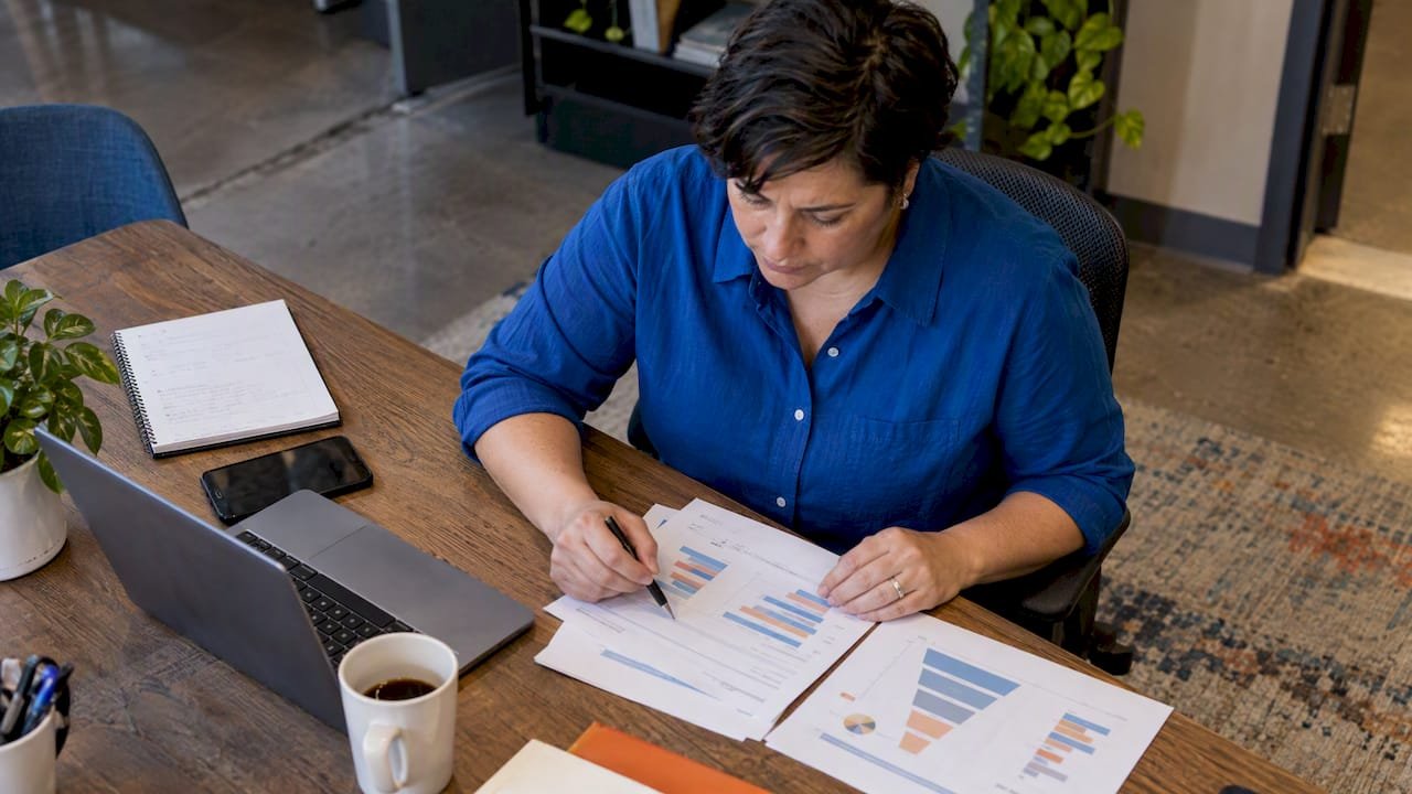 Analyst reviewing a printed funnel report